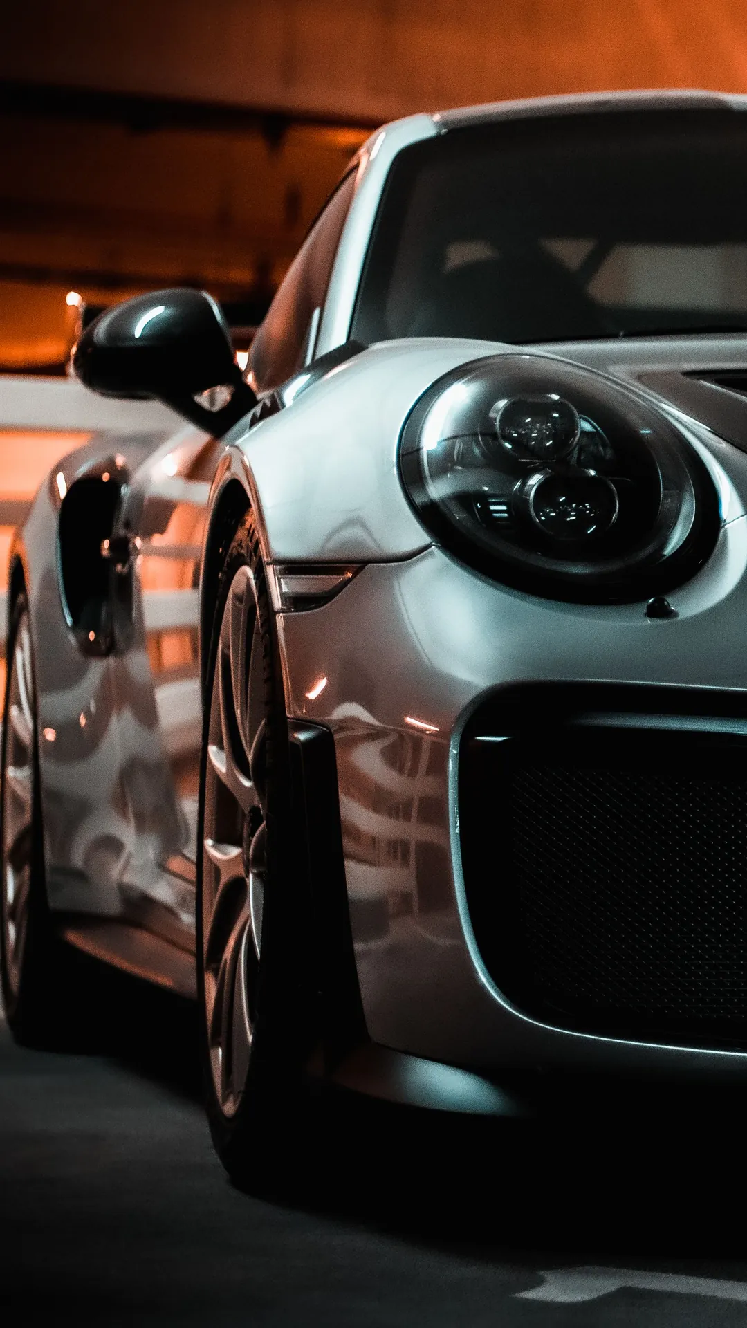 Premium sports car with a deep, glossy ceramic-coated finish in a detailing studio