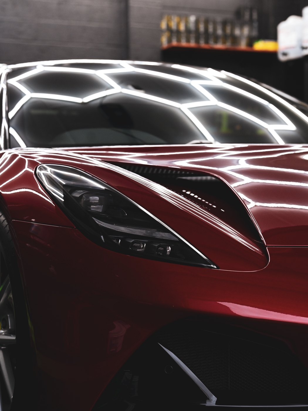 A freshly detailed, ceramic-coated Lotus Emira reflecting studio lighting in deep gloss